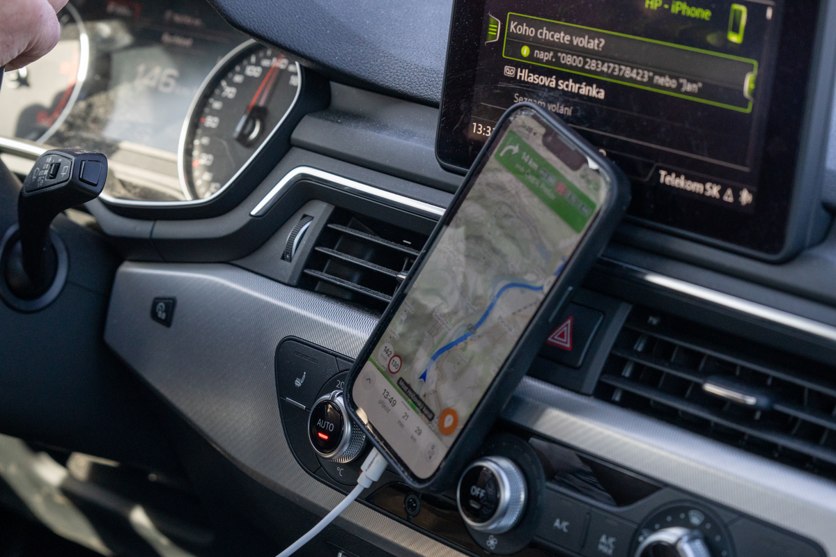 Smartphone mounted on car dashboard showing navigation map with speed limit 130 km/h on Czech D1 motorway, February 2026