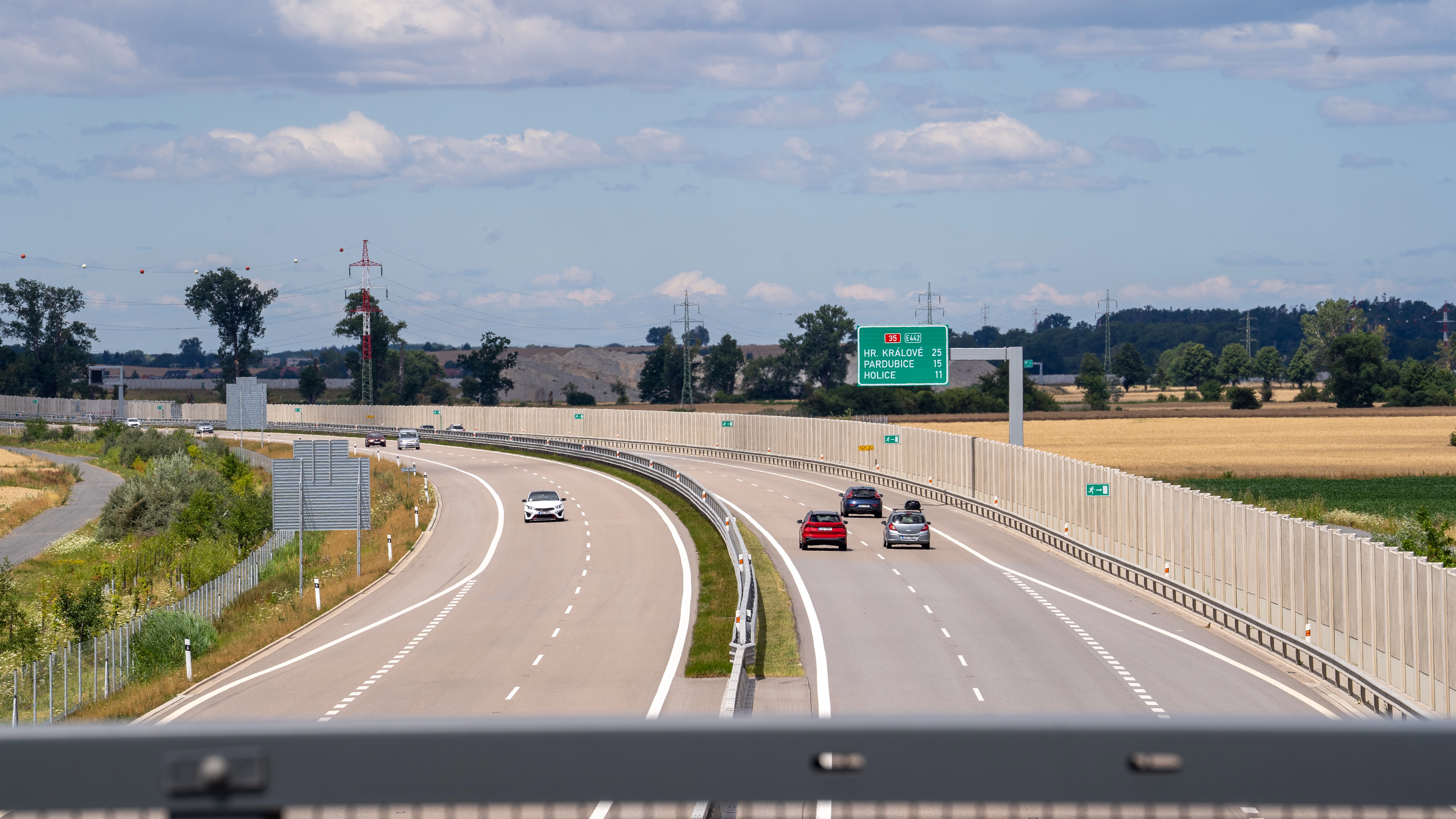 The D35, one of the Czech Republic's major toll motorways (E442), with traffic toward Hradec Králové, Pardubice and Holice through summer farmland