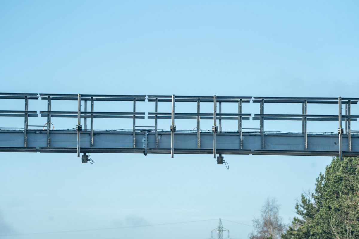 Close-up of Czech D5 motorway vignette enforcement gantry with detection sensors mounted underneath against clear blue sky, February 2026