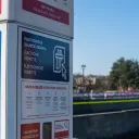 Close-up of an edalnice.cz Czech e-vignette kiosk with Czech, English and German signage, purchase instructions and call centre details, beside a motorway. February 2026.