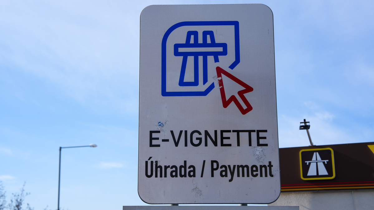Czech e-vignette Úhrada payment sign with blue motorway click icon and red cursor at Czech-German border crossing near Dresden, February 2026