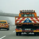 Czech road maintenance service vehicles on D5 motorway in foggy winter weather