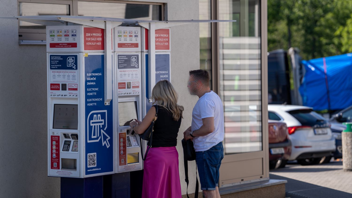 Travellers buying a Czech e-vignette at a self-service machine that shows the 1-year, 30-day, 10-day and 1-day vignette options