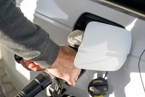 Close-up of a hand fueling a car with diesel at a petrol station in the Czech Republic, captured on February 26, 2026