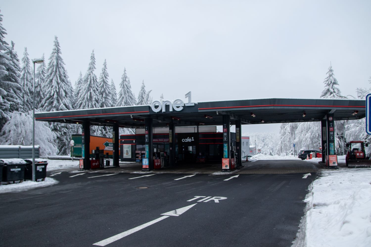 Snow-covered one1 filling station among pine trees near the Czech border, one of the stops in the European Motorway Stop Index